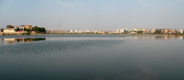 A city skyline across a calm lake