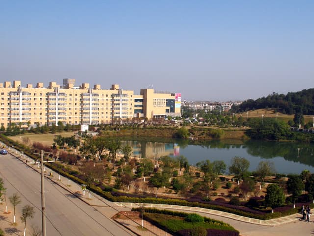 A large body of water surrounded by trees and buildings in a city