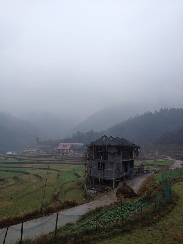 A building on a foggy mountain