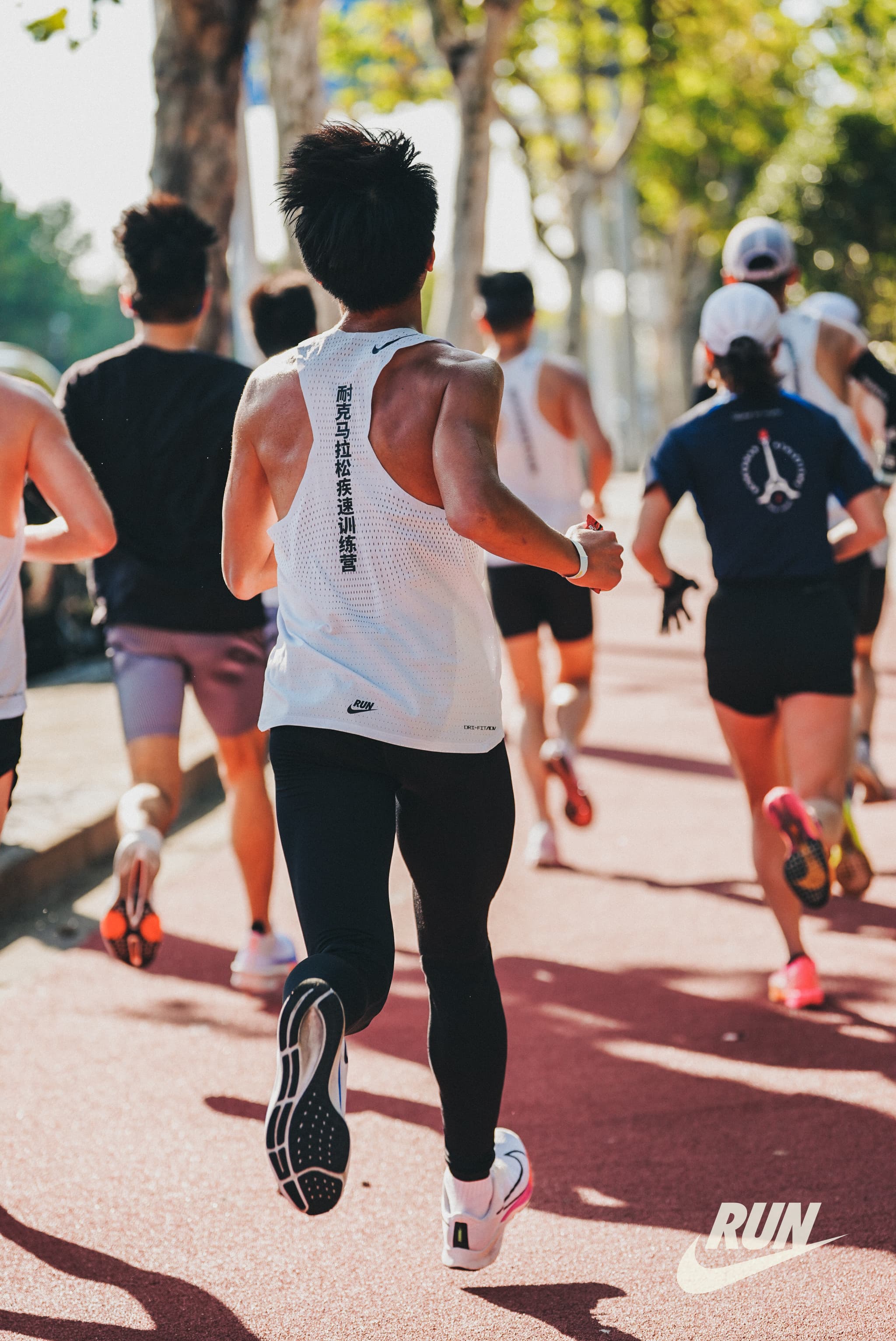 a group of people running on a sidewalk