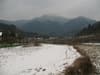 Snowy field with mountain range in the background