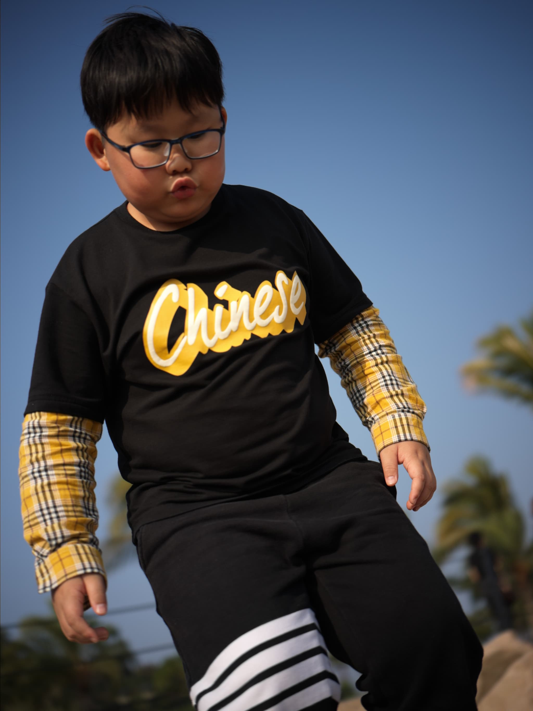 man wearing black and yellow shirt with white striped pants