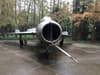 Close-up of an aircraft engine with trees in the background