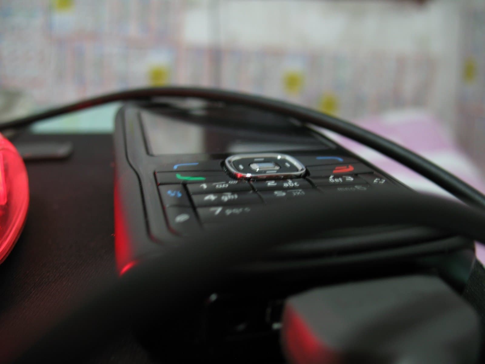 Closeup of a steering wheel with buttons and controls