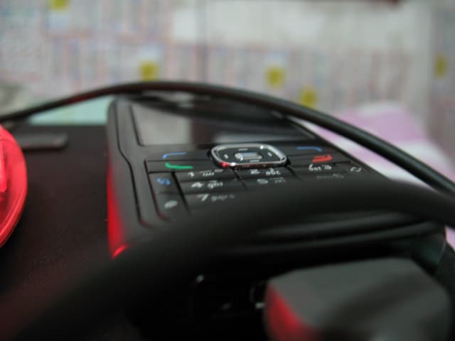 Closeup of a steering wheel with buttons and controls