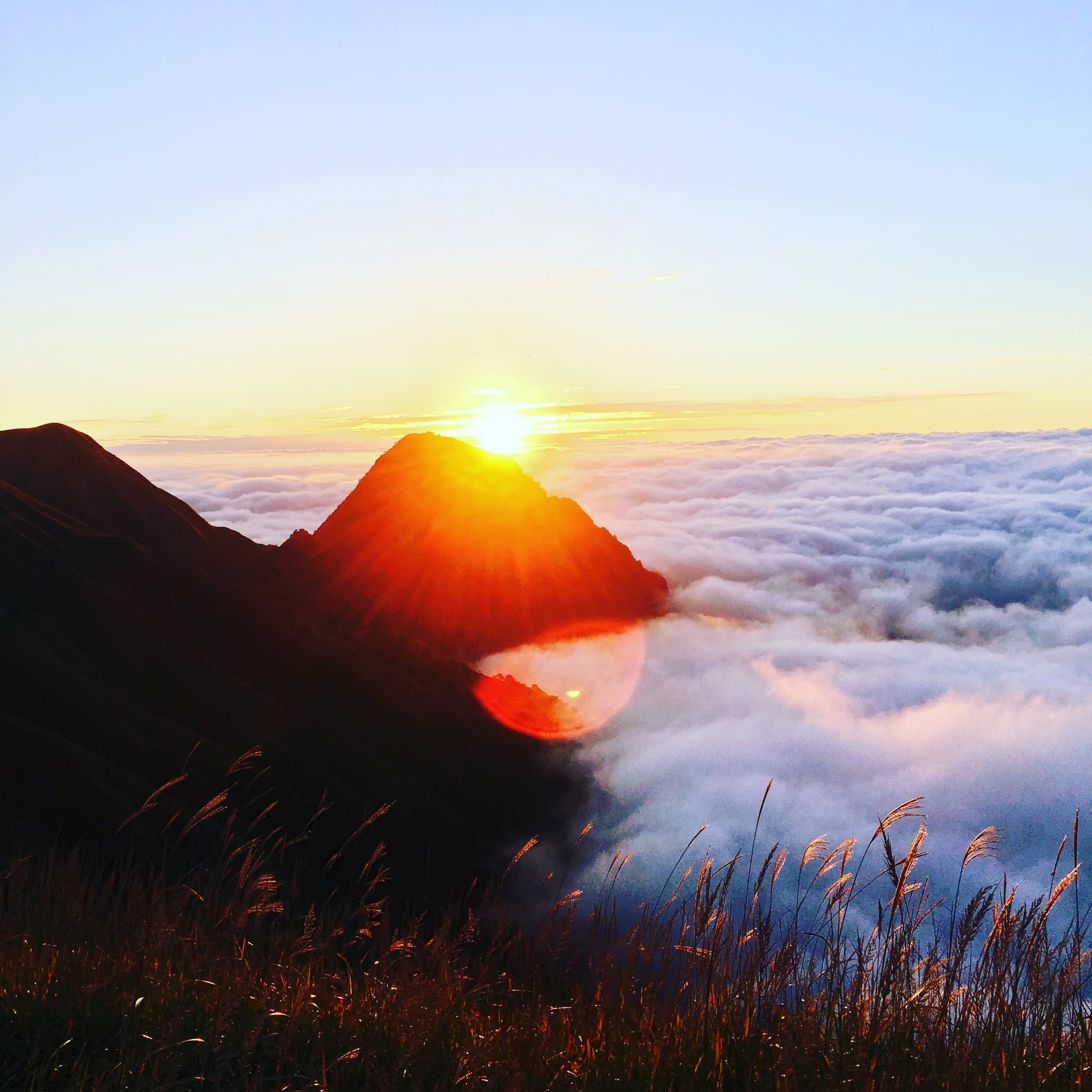 sunrise over a mountain above the clouds