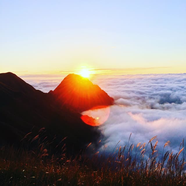 sunrise over a mountain above the clouds
