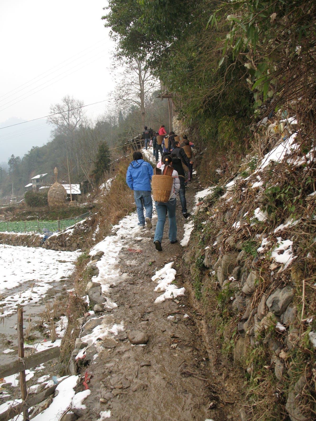People hiking on a snowy mountain trail